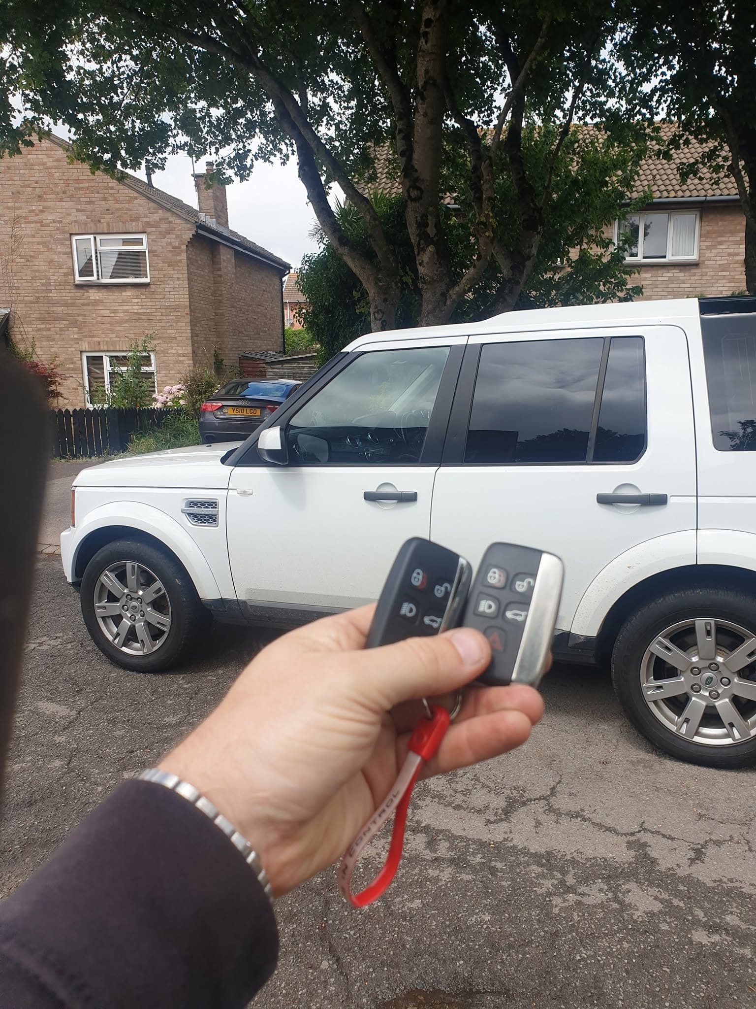 Two replacement remote keys for a white Land Rover Discovery