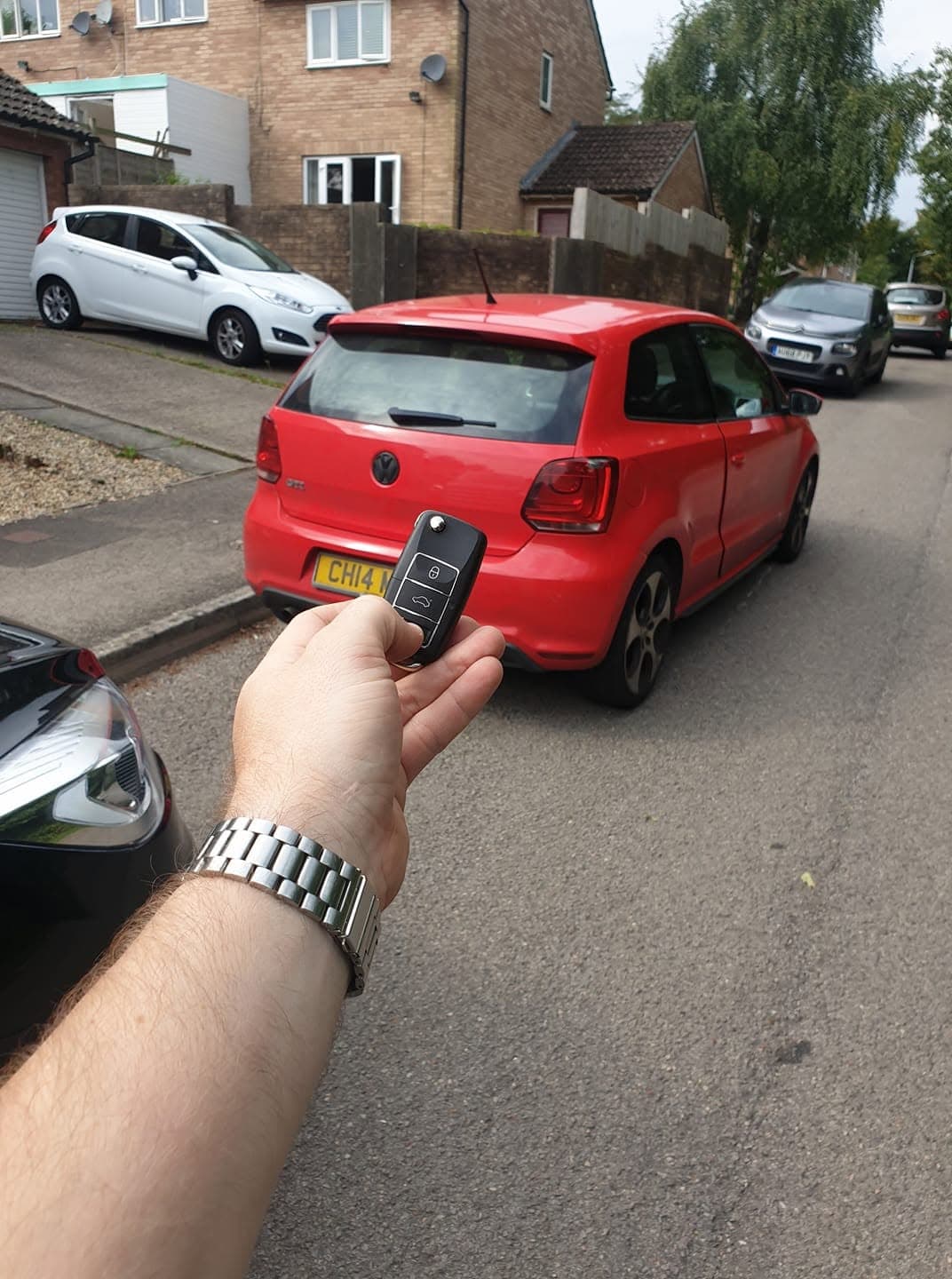A replacement VW flip key programmed for a red VW Polo GTI